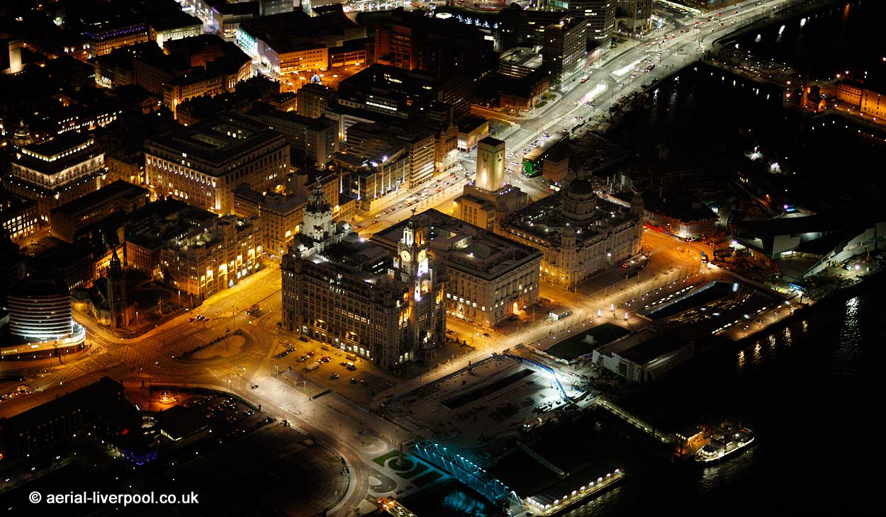 aerial photograph of the Three Graces
        by night. Three Graces are The Royal Liver Building, The Cunard
        Building and Port of Liverpool building at Pier head on the
        Liverpool Waterfront England UK
